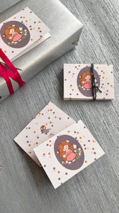 Folded gift card personalised with a name featuring a cute girl on an oval grey background surrounded by polka dots 