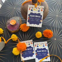 Decorative items with 'Happy Diwali' cards on a patterned background