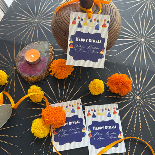 Decorative items with 'Happy Diwali' cards on a patterned background