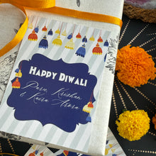 Greeting card with 'Happy Diwali' text and decorative elements on a patterned surface.
