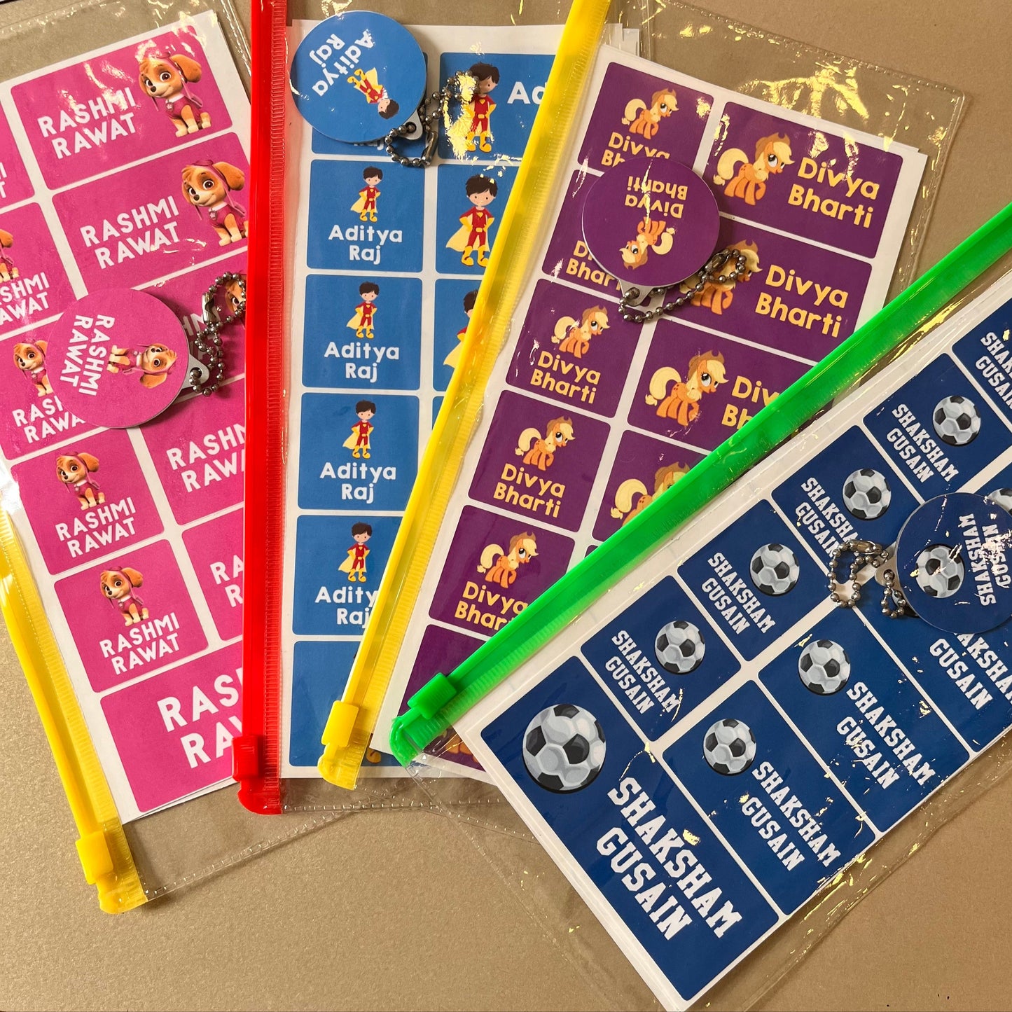 Stickers with names and cartoon characters in a transparent ziplock bag for return gifts