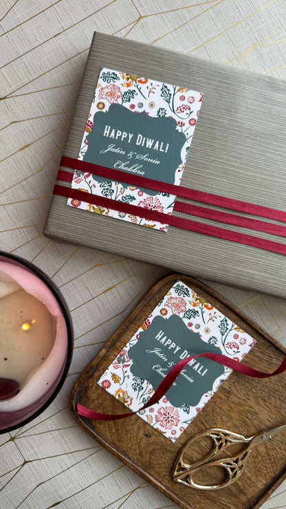 Gift box with 'Happy Diwali' card on a wooden surface