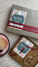 Gift box with 'Happy Diwali' card on a wooden surface