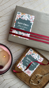 Gift box with 'Happy Diwali' card on a wooden surface