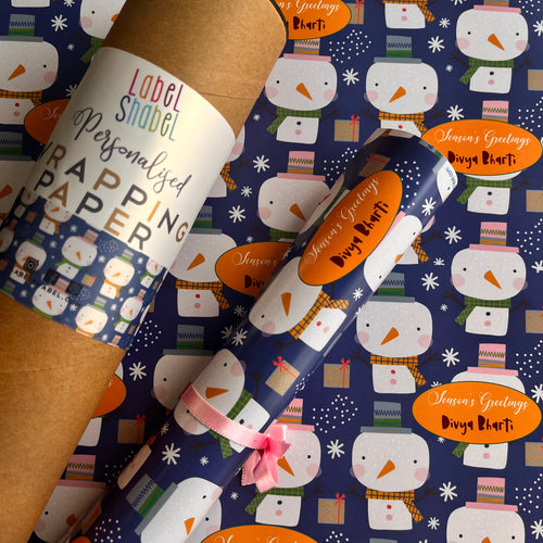 A roll of personalized wrapping paper with a snowman pattern, custom labels, and a ribbon.