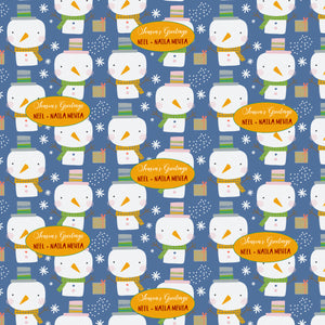 Personalised xmas wrapping paper with blue background and a snowman and snowflakes with a yellow box with names on it