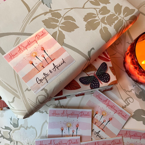 Striped background in pink hues with sparklers and diwali wishes