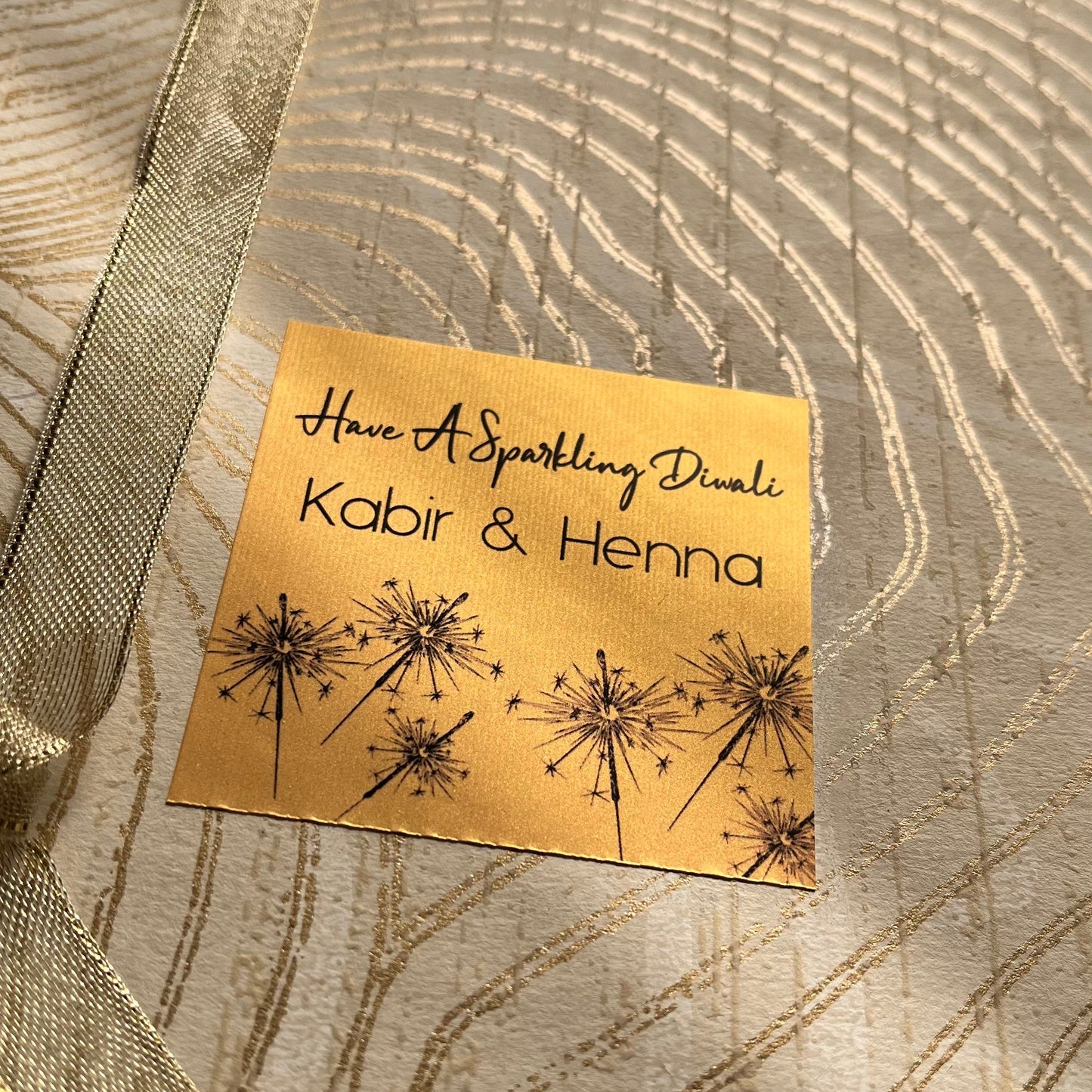 Gift label in golden paper with diwali sparklers and a perosnalised name