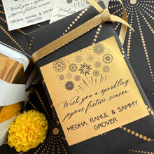 Gift box with decorative label and yellow flower on a patterned background