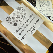 Gift box with gold and white stripes and a personalized card on a black background