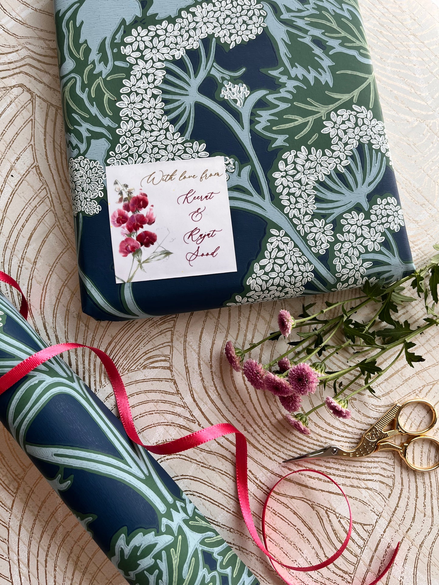 a white background gift label with a bunch of sweet pea flowers and a cursive style font for name