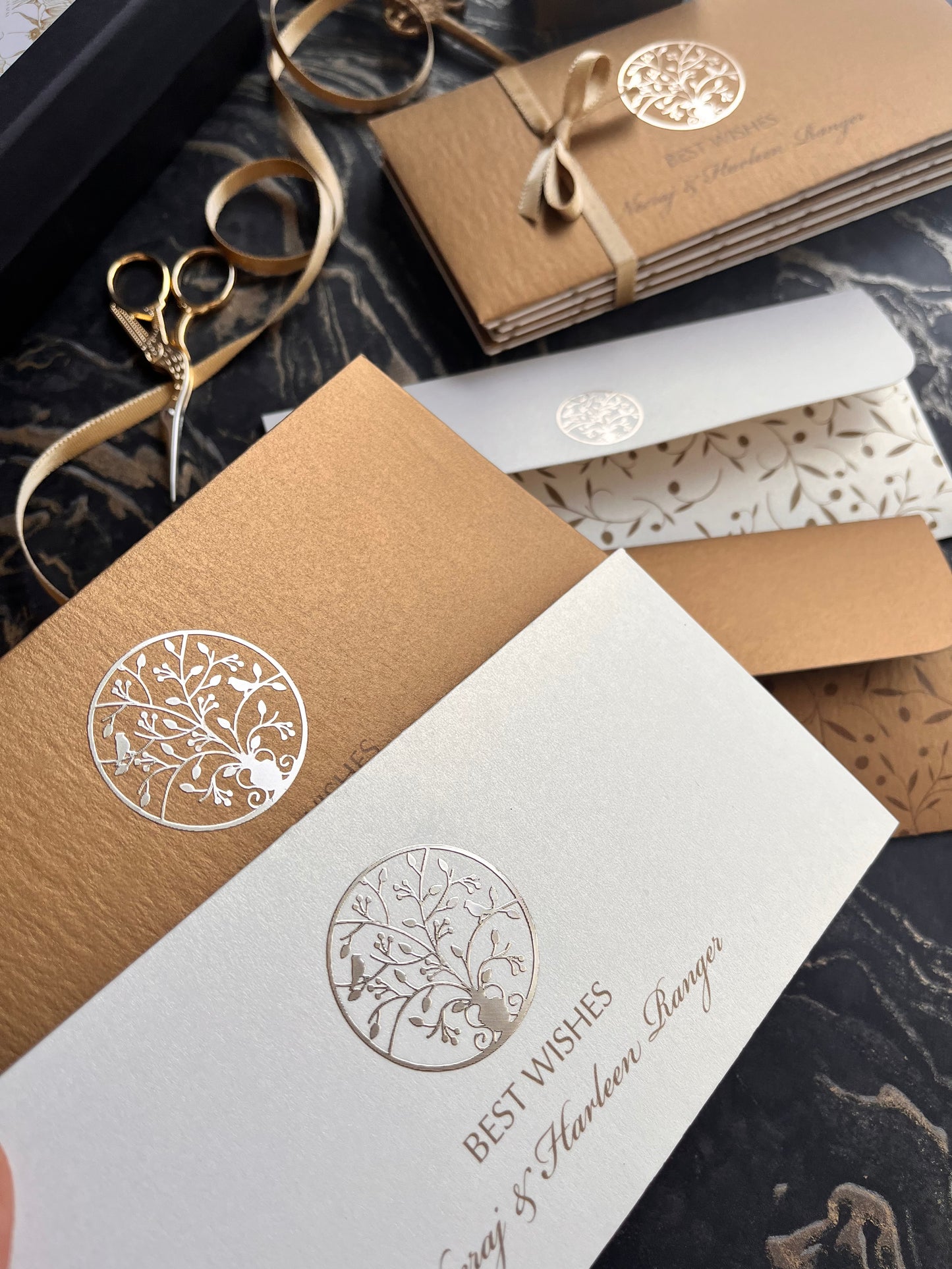 Gift Envelopes  with tree of life round metal motif  on a textured surface 