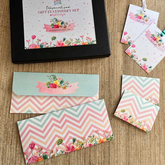 Personalized gift stationery set with envelopes and cards on a wooden surface