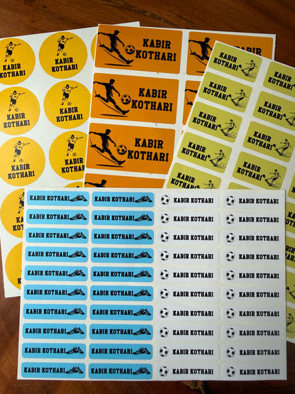 Several sheets of waterproof name label round and rectangular stickers  yellow, orange, and light blue backgrounds, with black silhouettes of football  players and soccer balls.