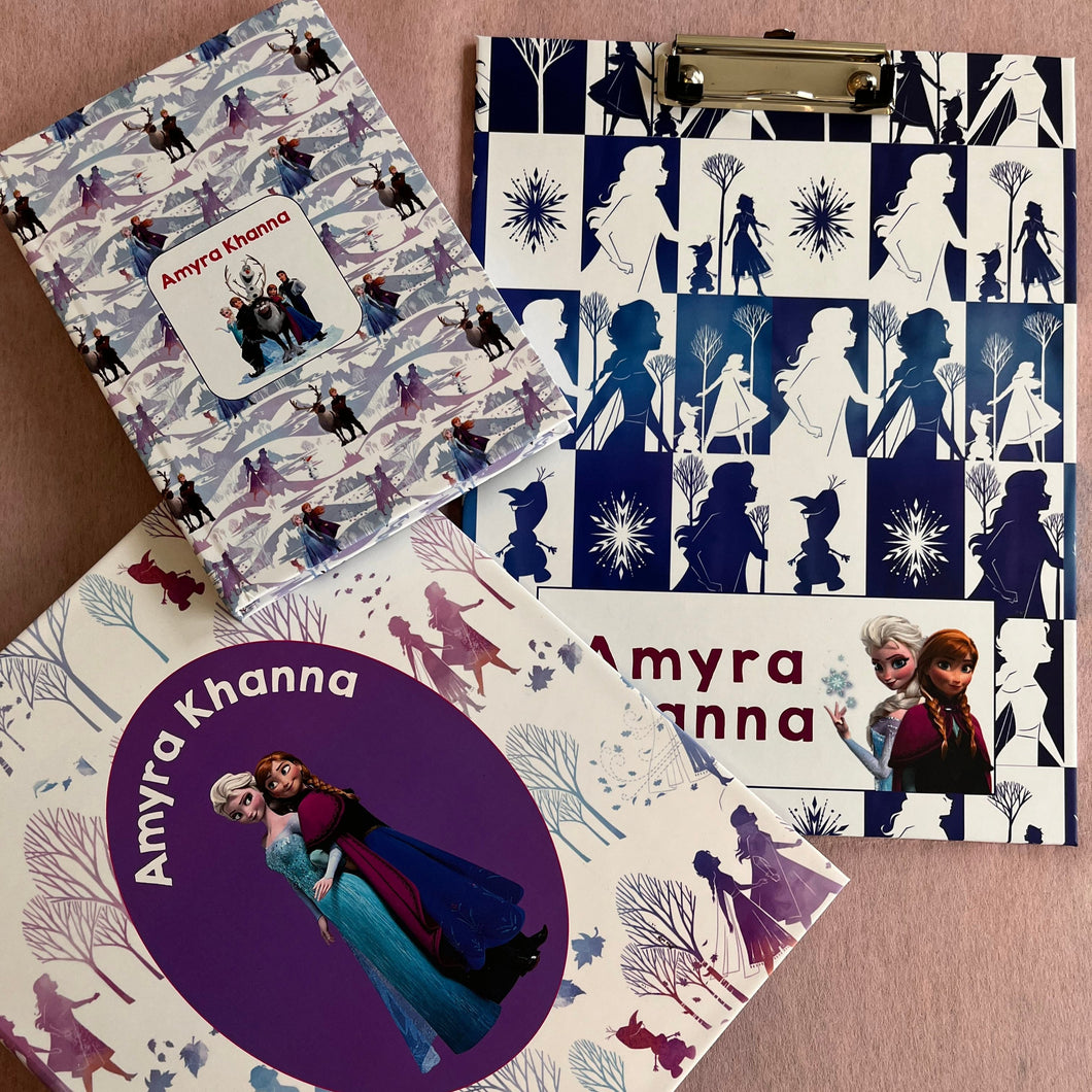 Customized school set with Frozen movie characters, including a notebook, a clipboard, and a folder, each with personalized name branding.