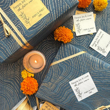 Decorative setting with candles, ribbons, and flowers on a textured surface