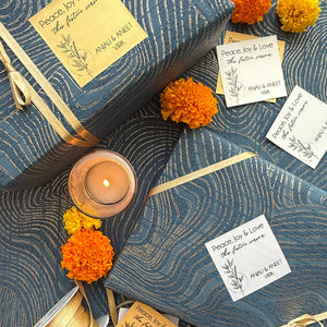 Decorative setting with candles, ribbons, and flowers on a textured surface