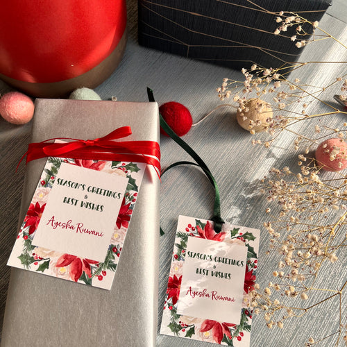 Xmas ribbon tag with bright xmas foilage in shades of green red