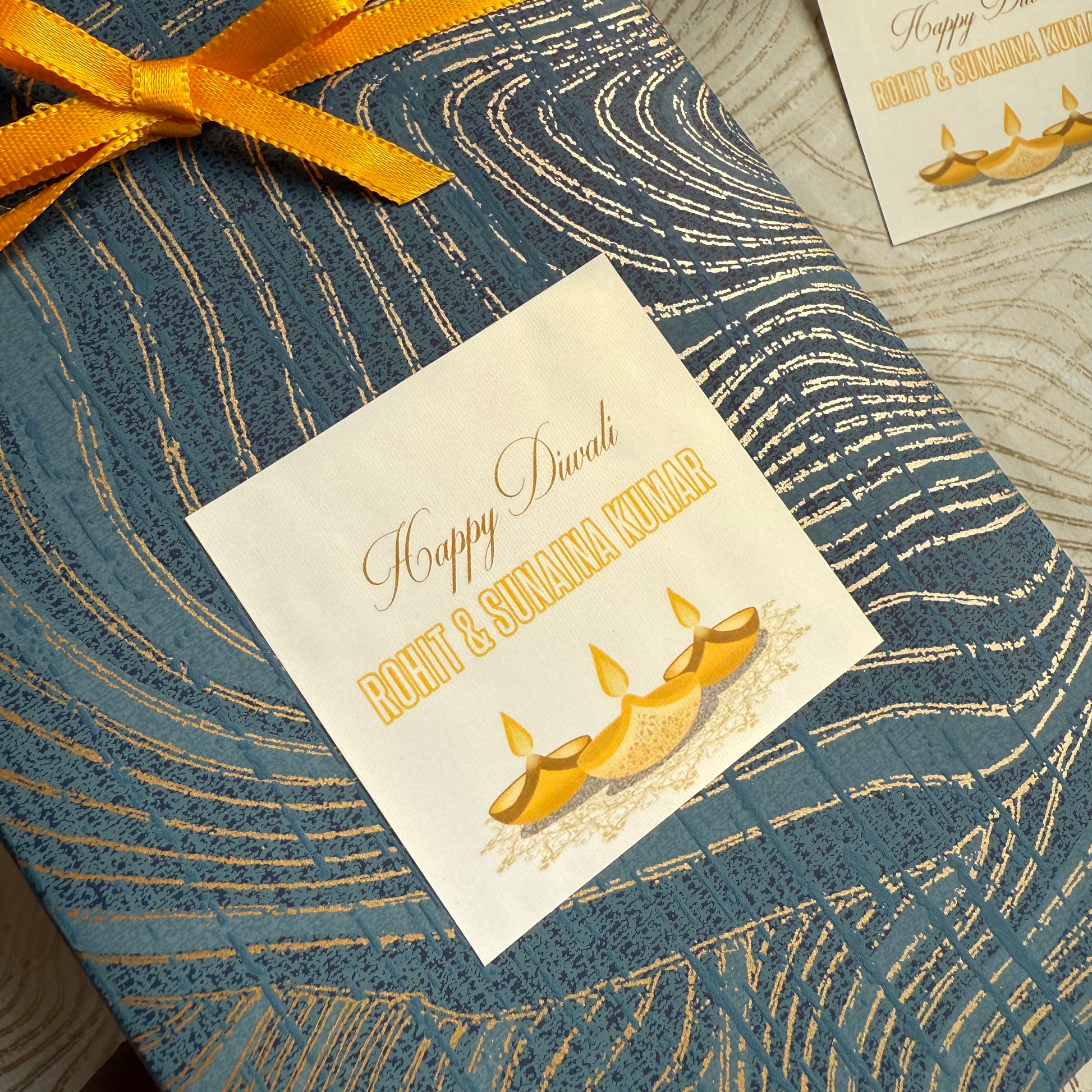 Gift box with a decorative label for Diwali on a textured surface