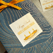 Gift box with a decorative label for Diwali on a textured surface