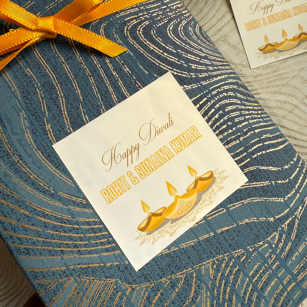 Gift box with a decorative label for Diwali on a textured surface