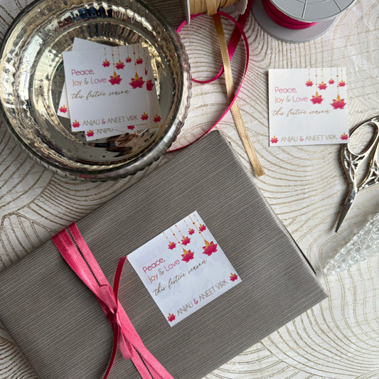 Gift box with pink ribbon and decorative label on a textured surface