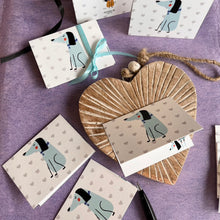 folded gift tag with cute dog in blue on background of grey hearts and a cute dog inside with name
