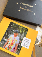 Photo book cover in bright yellow with a boy being sprayed with water and a quote on the side.