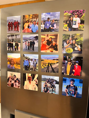 A collection of various photo magnets arranged on a metallic surface, displaying different images including portraits and scenic shots.