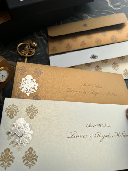 Decorative envelopes with floral designs on a marble surface.