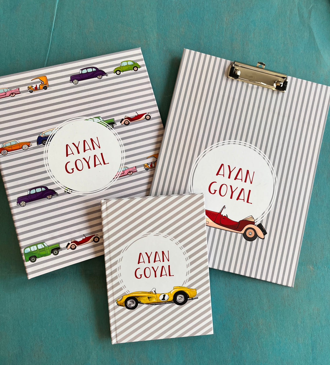 Customized school set with  cars, including a notebook, a clipboard, and a folder, each with personalized name branding.