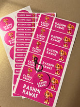 Sheet of pink stickers with a cartoon character and a name on a beige background