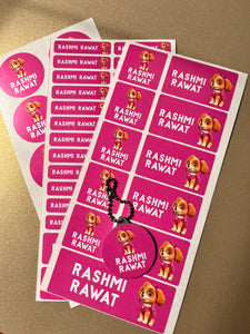 Sheet of pink stickers with a cartoon character and a name on a beige background