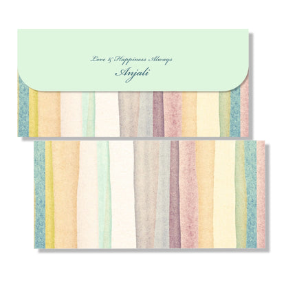 A stack of multicolored gift envelopes with a solid pattern and a name written on the top envelope.