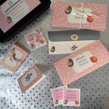 Set of pink stationery set with envelopes, gift labels and gift tags with decorative elements on a polka dot surface