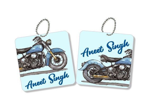 A pair of metal bag tags with a motorcycle image labelshabel